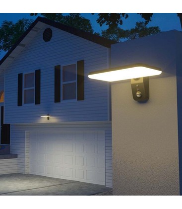 Moderne sort solcelle vegglampe montert på en husvegg som viser praktisk utebelysning.